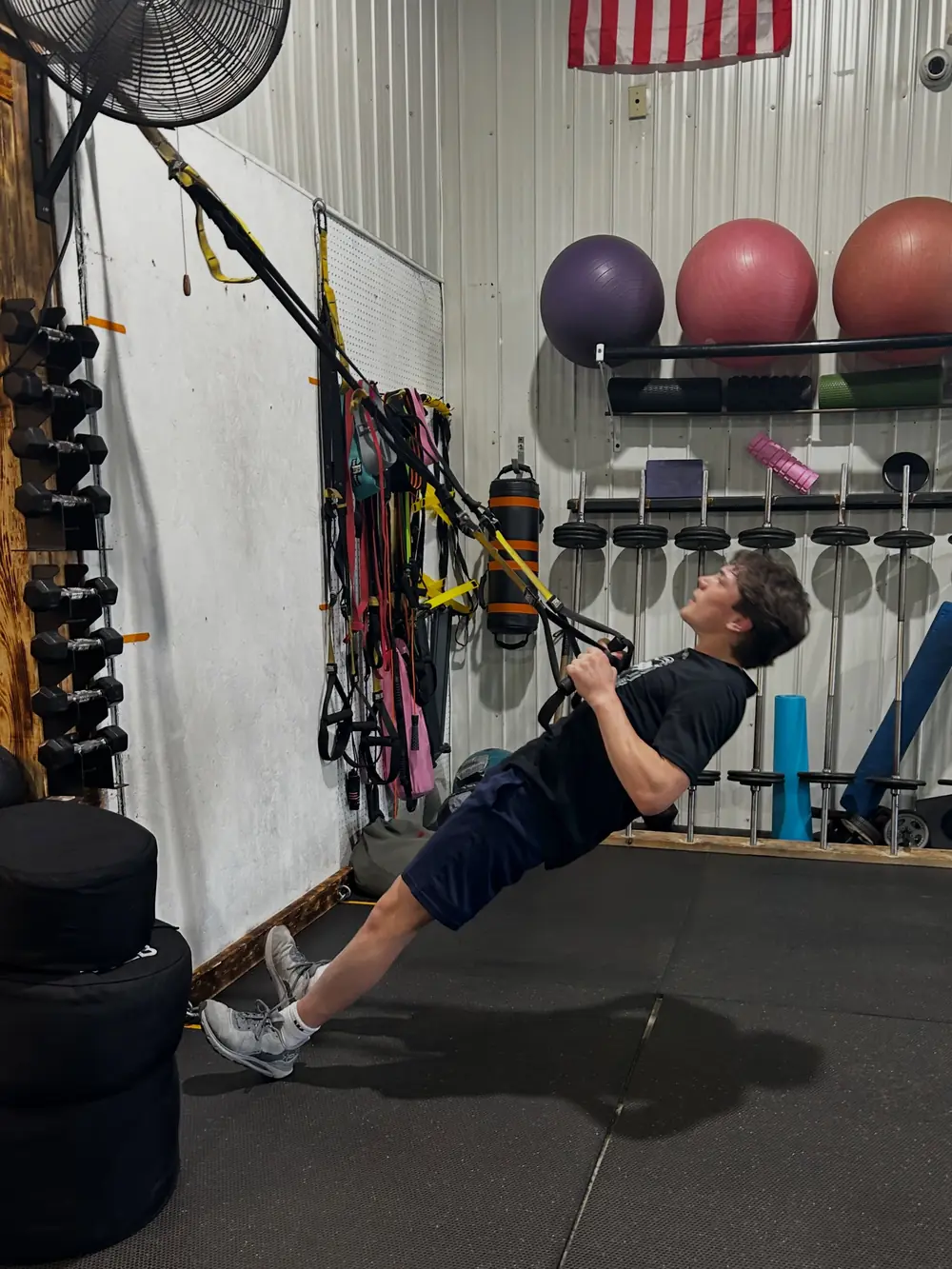 An athlete working through a TRX row during a session