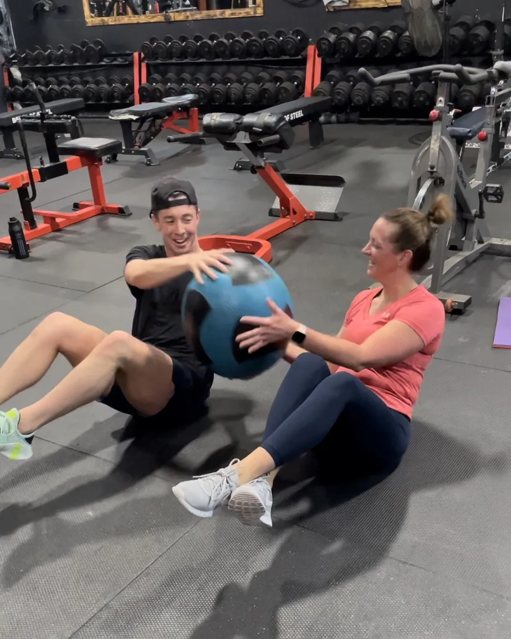 Kyle and a client working through a partner medicine ball exercise