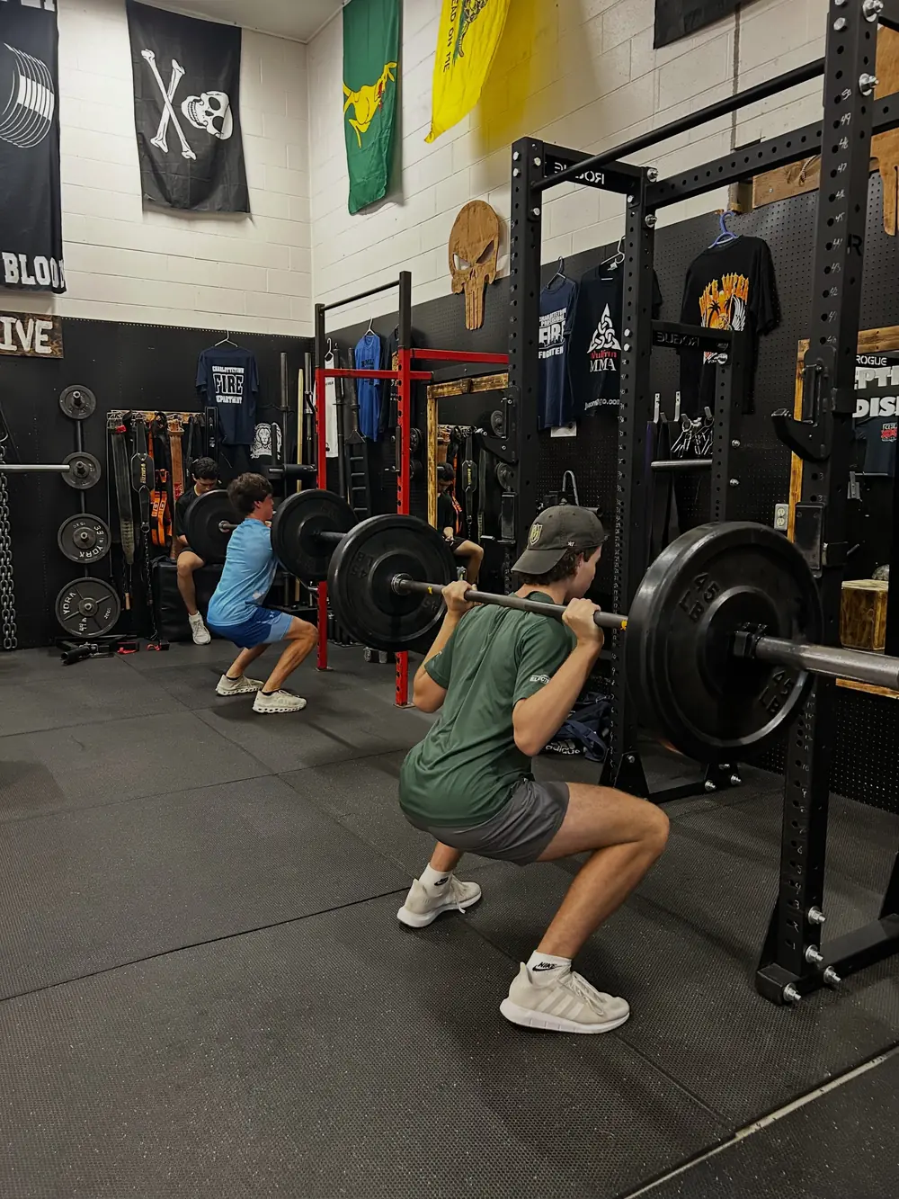 An athlete back squatting during a summer training session