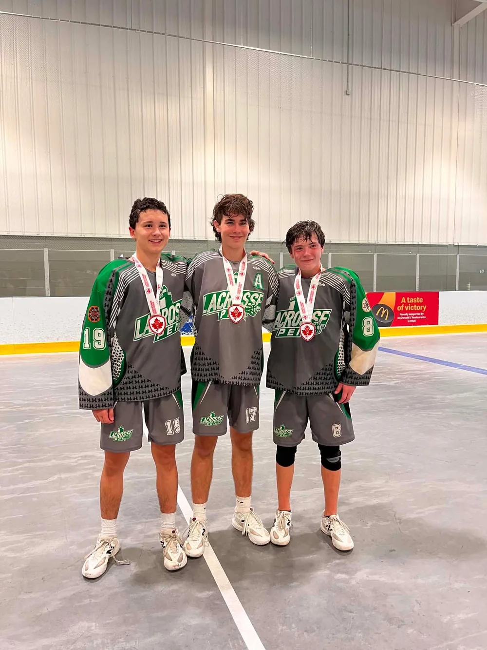 Three K2 athletes with their bronze medals at Nationals